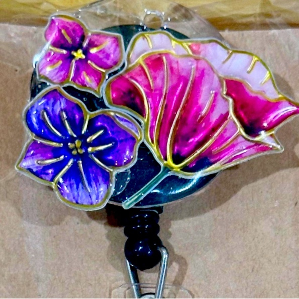 Multicolor floral badge reel with belt clip